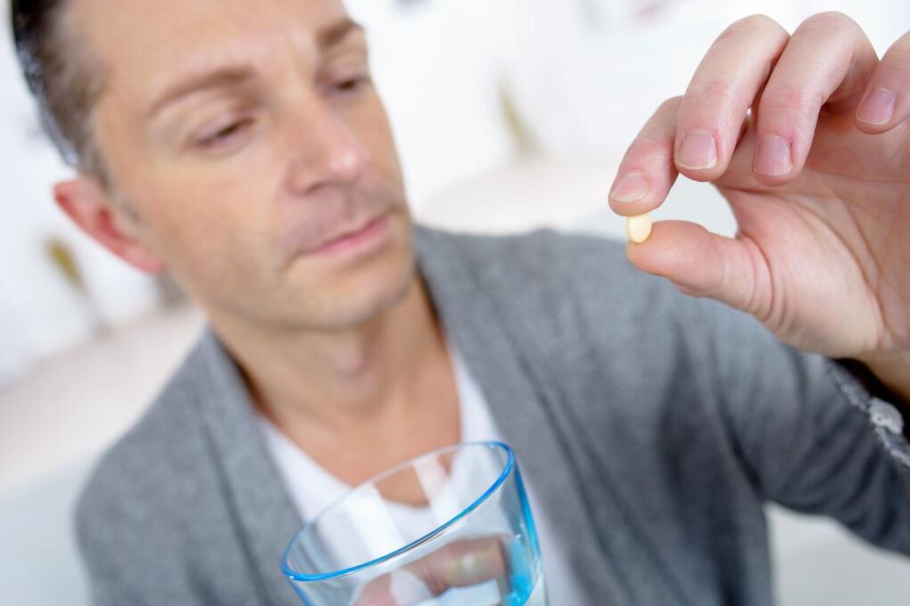 a man takes a pill to increase strength